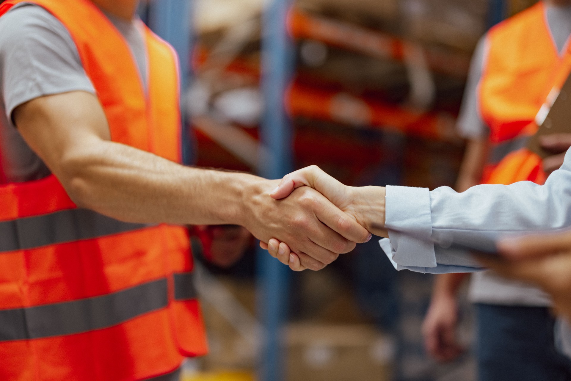 Warehouse manager hiring an employee and handshaking his hand